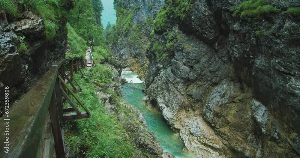 Mountain stream with fresh clear water flows in Lammerklamm Dark Gorge in Austria. Alpine landscape at rainy day. Mountain stream with fresh clear water flows in Lammerklamm Dark Gorge in Austria. Alpine landscape at rainy day.