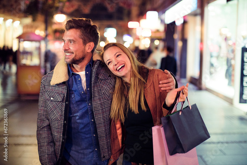 Young couple enjoying a shopping evening in the city