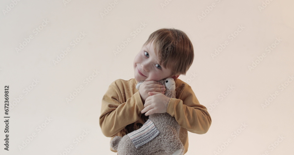 Portrait of a little boy with a soft toy in his hands. Shooting in the studio Portrait of a little boy with a soft toy in his hands. Shooting in the studio