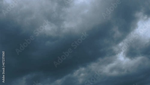 Hurricane gray clouds. Puffy fluffy dark clouds. Cumulus cloudscape real time footage. Autumn or winter sky 4k video. Nature weather forecast. Rainy cloud background. Cloudy dramatic storm or cyclone photo
