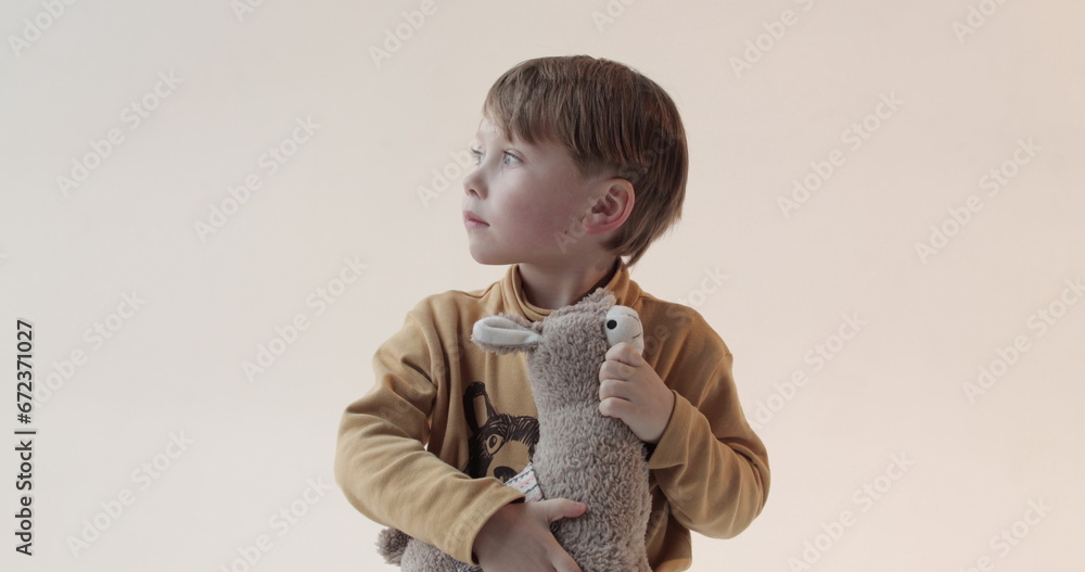 Portrait of a little boy with a soft toy in his hands. Shooting in the studio Portrait of a little boy with a soft toy in his hands. Shooting in the studio