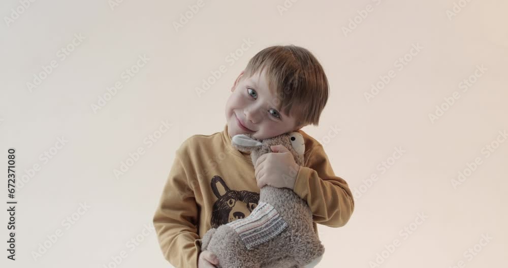 Portrait of a little boy with a soft toy in his hands. Shooting in the studio Portrait of a little boy with a soft toy in his hands. Shooting in the studio