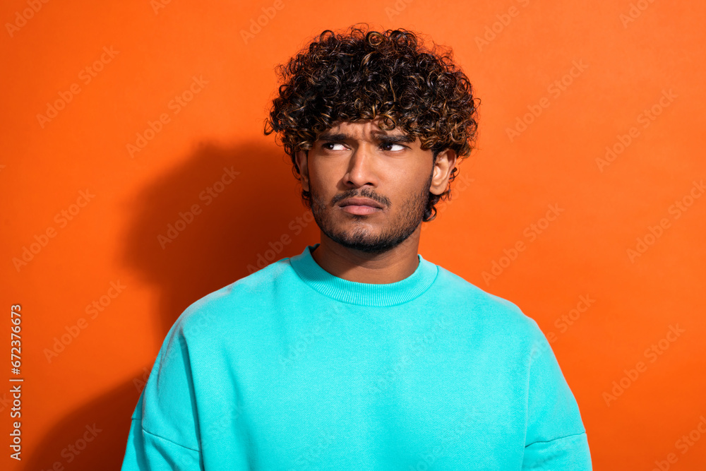 Portrait of minded pensive person look interested empty space contemplate hesitate isolated on orange color background Portrait of minded pensive person look interested empty space contemplate hesitate isolated on orange color background