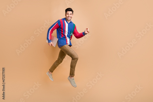Full length size photo of running guy funny workaholic programmer love his job bring new netbook isolated on beige color background