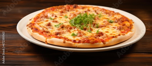 A wooden table adorned with a white dish holds a pizza