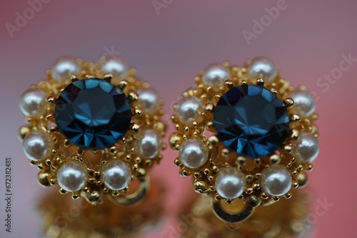 Closeup of pair of earrings with diamonds