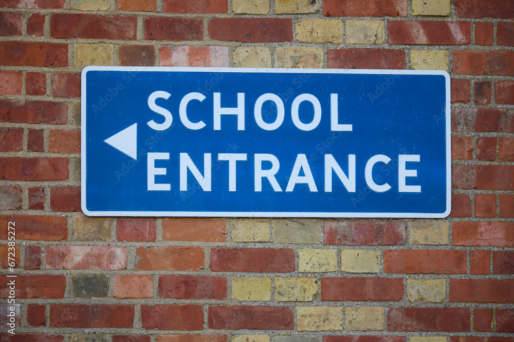 School Entrance Sign On Brick Wall Of School Building School Entrance Sign On Brick Wall Of School Building