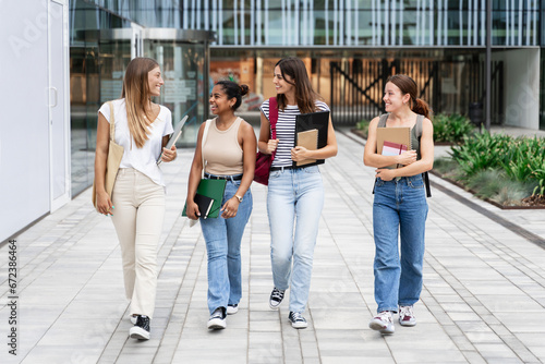 Cheerful Female University students walking outside the Business Administration Faculty