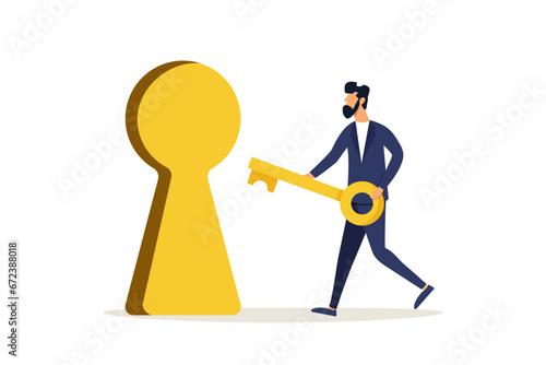 Smart businessman holding a golden key to open a keyhole. The key is to find the answer to the problem and questions, the solution or reason to solve the problem, wisdom or understanding of the concep