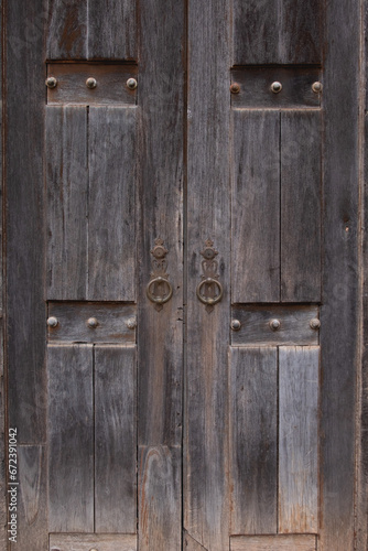 Old vintage retro style wood door with rusty handles background and texture.