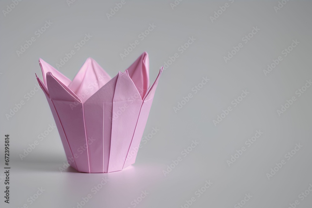 Close-up view of a small pink paper origami bowl against a white background Close-up view of a small pink paper origami bowl against a white background