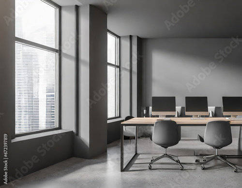 Grey coworking interior with pc computers on desk, window. Mock up wall