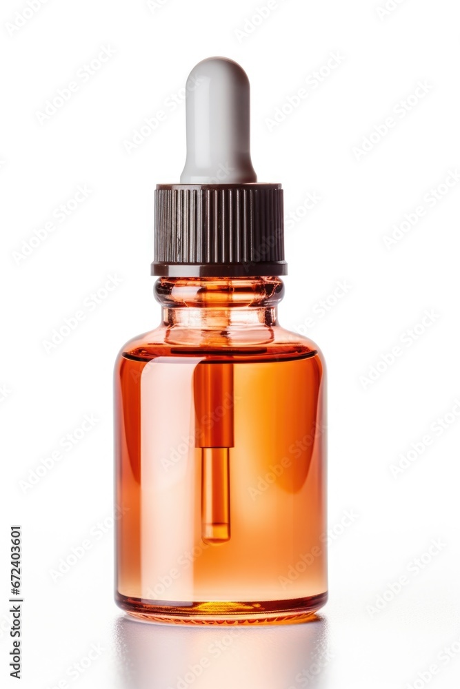 A glass bottle with a dropper sitting on a white surface. A glass bottle with a dropper sitting on a white surface.