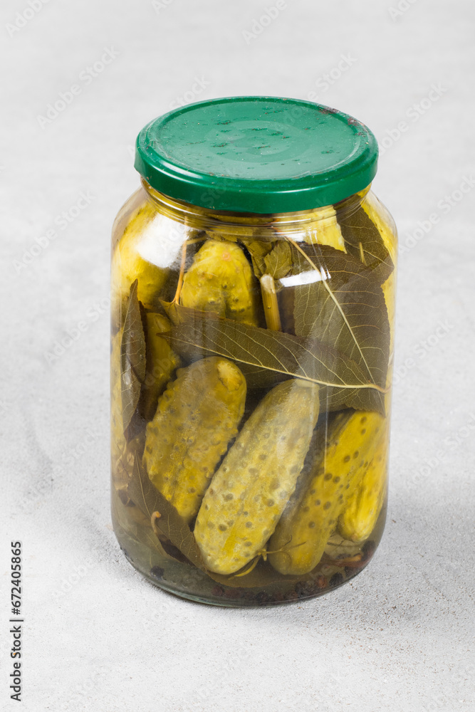 Pickled cucumbers in a glass jar with a lid. Close up Pickled cucumbers in a glass jar with a lid. Close up