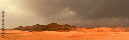 Tadrart and Tassili n'Ajjer mountains in the Algerian part of the Sahara, dark storm clouds, horizontal panoramic view
