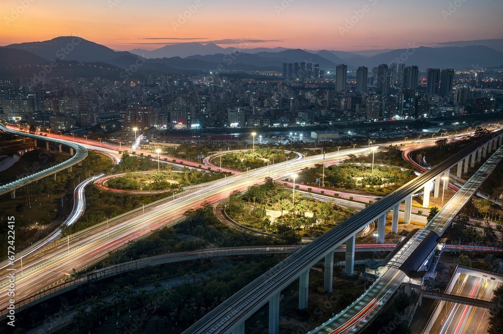 Freeways in an empty city at dusk with the sun setting