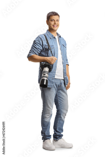 Full length portrait of a male photographer carrying a professional camera and smiling © Ljupco Smokovski