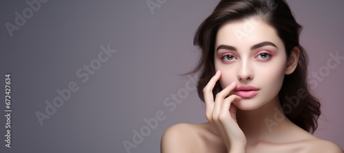 Young woman caressing cared skin, pink background, ad banner