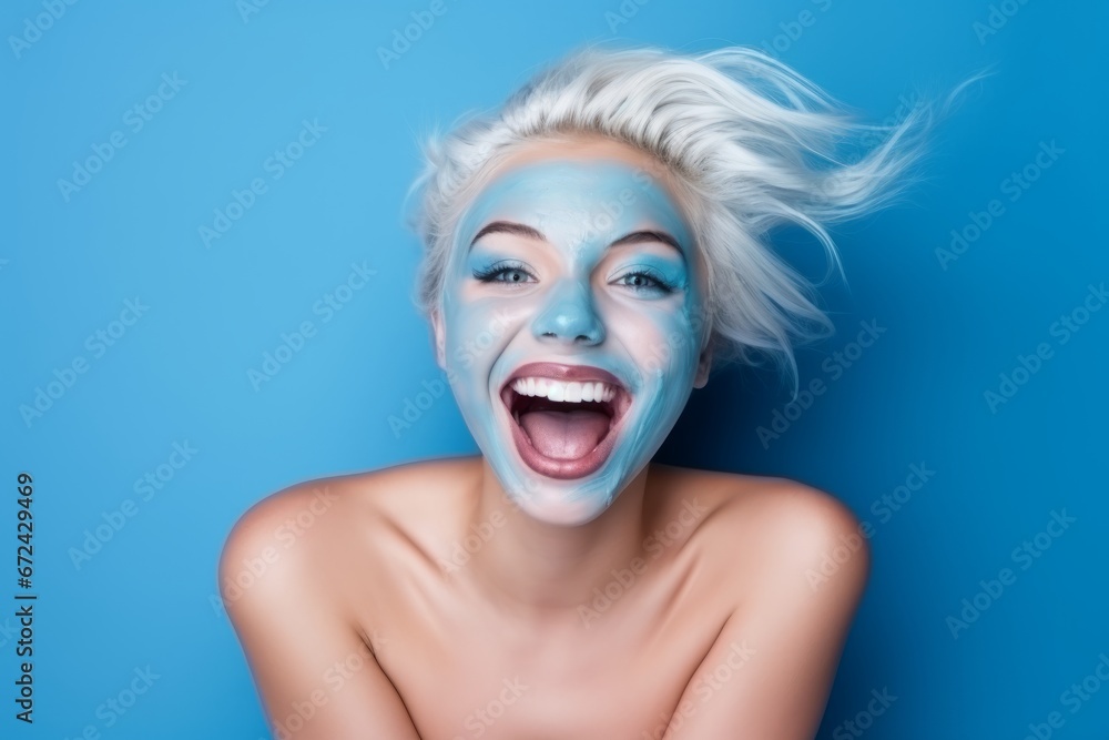 Blonde woman with a blue facial beauty mask.