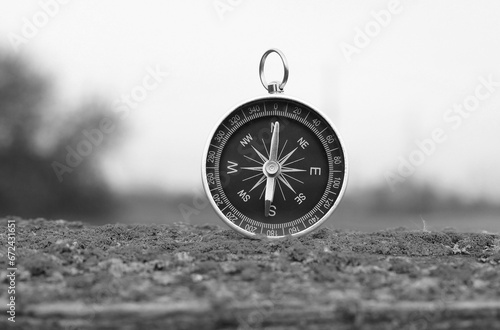 black and white photo of round compass