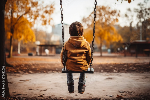 Child alone on playground swing background with empty space for text  photo
