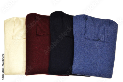 Smooth turtleneck folded wool sweaters on isolated background