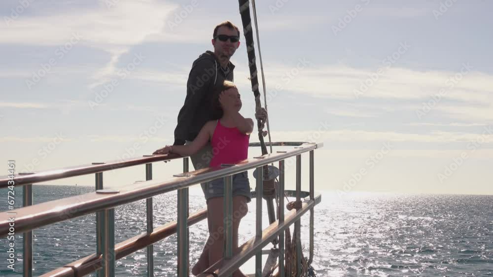 Father anf little girl in pink top and standing on the deck of the yacht Father anf little girl in pink top and standing on the deck of the yacht