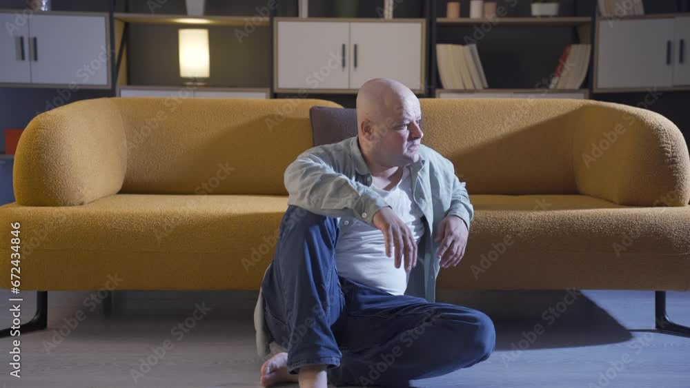 Depressed man sitting on the floor. Depressed man sitting on the floor.