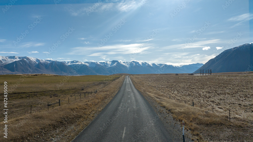 The way to Lake Ohau and the southern alps through alpine grasses and tundra terrain