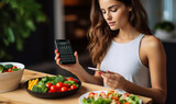 Young Woman Using Calorie Counter App While Enjoying Vegetable Salad