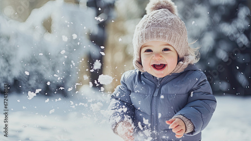 young toddler playing in snow in winter season