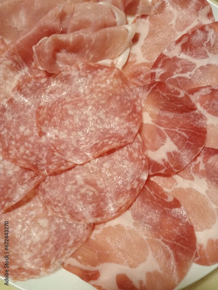 dish with slices of mixed cold cuts, ham, salami dish with slices of mixed cold cuts, ham, salami