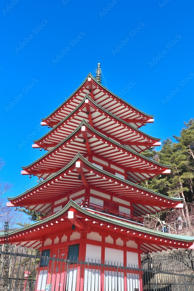 an oriental pagoda sits high above the park area in japan