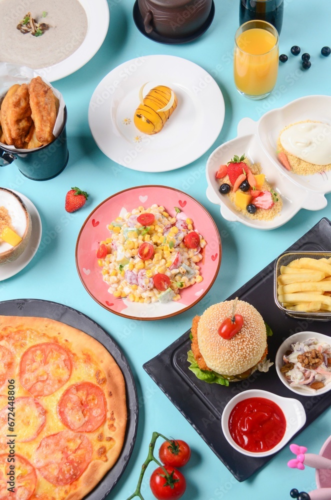 Top view of dishes from the Children's menu on a blue surface Top view of dishes from the Children's menu on a blue surface