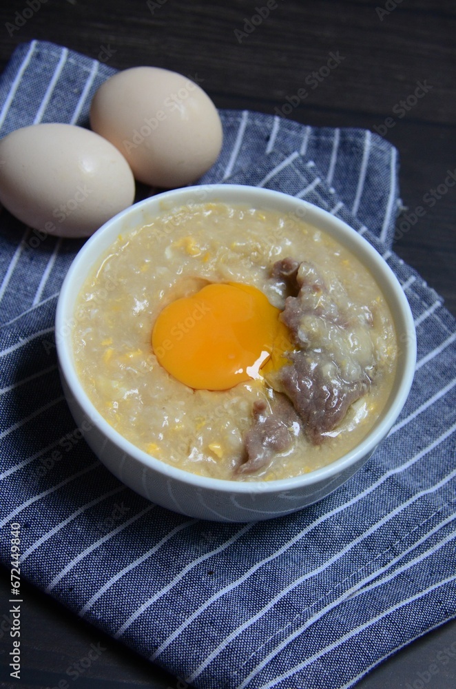 Bowl of traditional Chinese Porridge with an egg yolk on top Bowl of traditional Chinese Porridge with an egg yolk on top