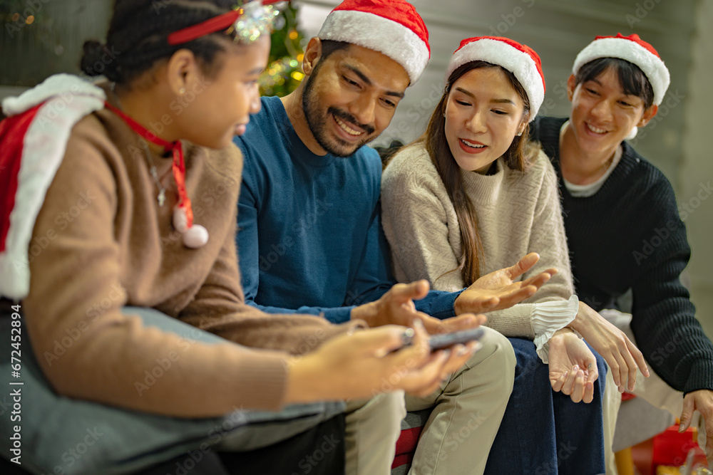 Fototapeta premium Party of asian Friends Enjoying Christmas Drinks and celebrating having selfie by smartphone. happiness women and man christmas eve celebrate dinner with food and beverage.