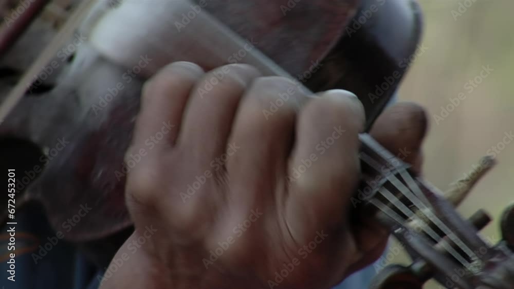 An Elderly Man Playing the Violin Outdoors in Chaco Province, Argentina. Close Up. An Elderly Man Playing the Violin Outdoors in Chaco Province, Argentina. Close Up.