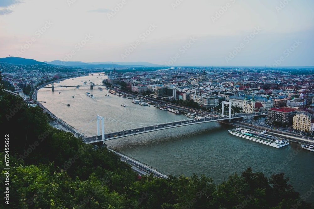Aerial view of Budapest cityscape with a bridge spanning a river in the city in the evening