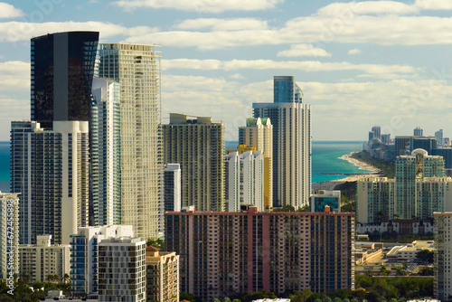 Sunny Isles Beach city with luxurious highrise hotels and condo buildings on Atlantic ocean shore. American tourism infrastructure in southern Florida