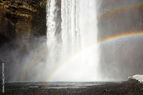 Rainbow near waterfall in nature photo