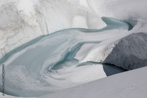 Snow covered landscape with stream during winter day