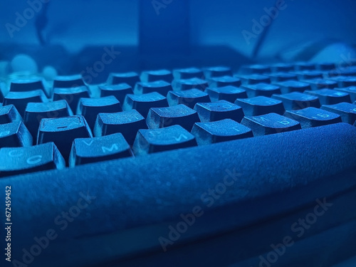 Detail of keyboard in low lighting in bluish hues