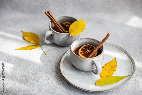 Spiced tea with autumn leaves photo