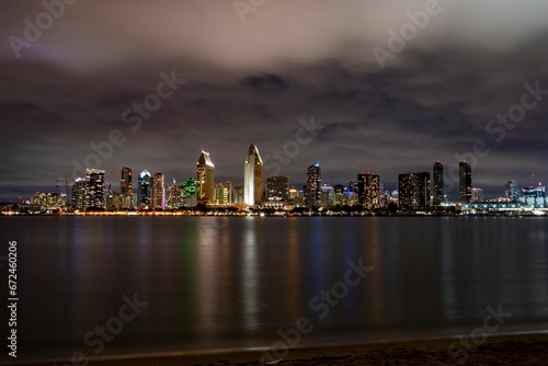 Night-time aerial view of a lake and a city skyline in the background  San Diego skyline