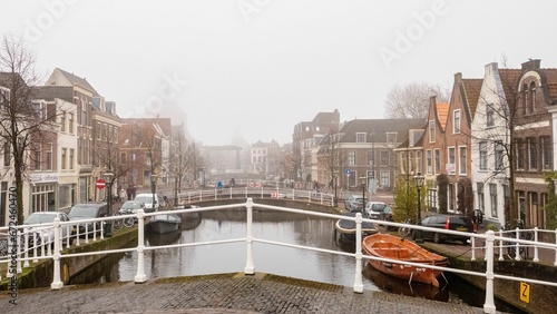 City landscape of Leiden with canals, dutch houses and boats. photo