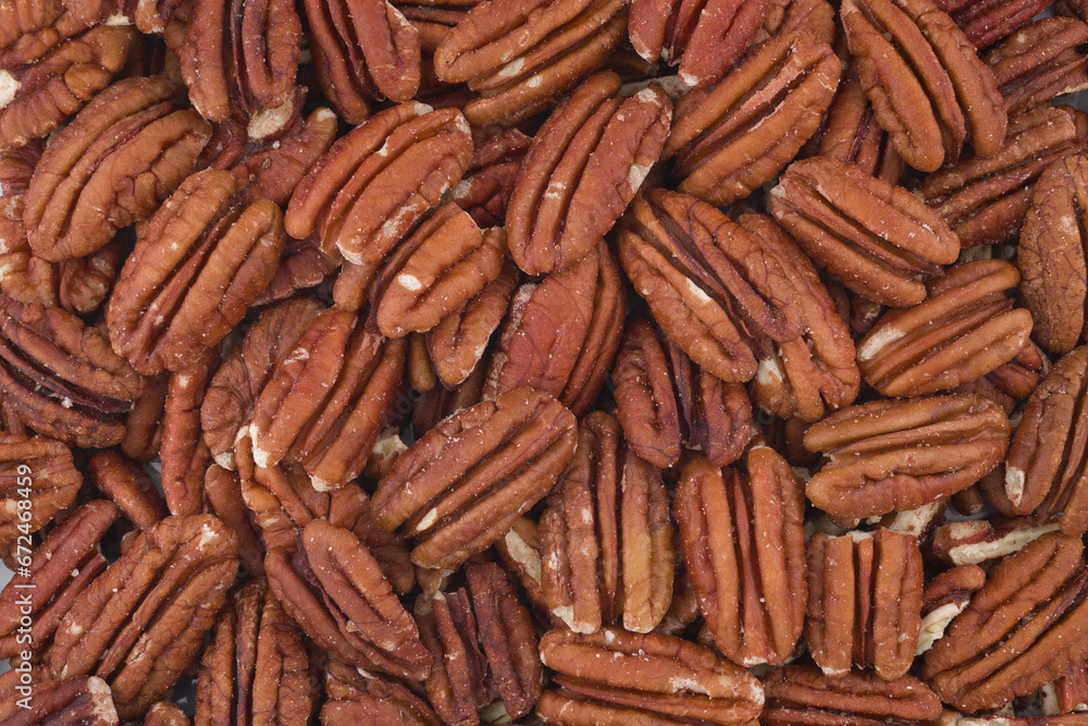 Cracked walnuts cores with more nuts as background. Cracked walnuts cores with more nuts as background.