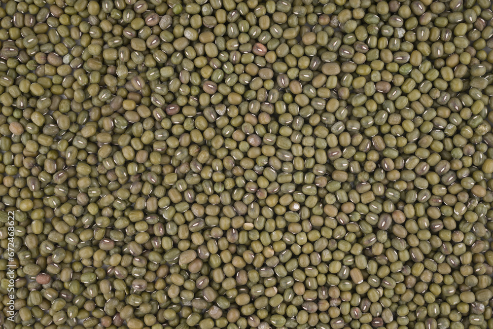 Crop of many dry green lentil grains on flat surface as background Crop of many dry green lentil grains on flat surface as background