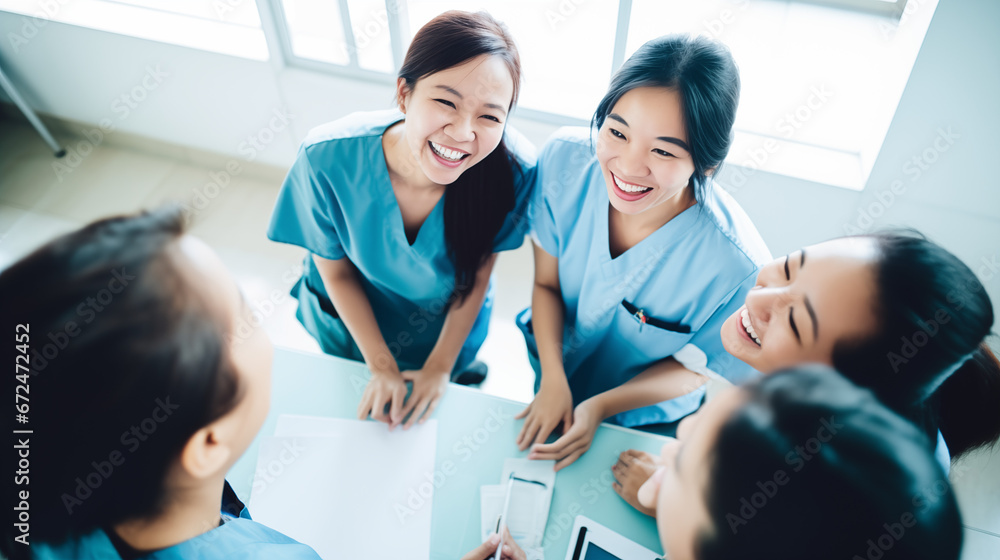 Obraz premium Asian Nurses in a Team Meeting: Sharing, Smiling, and Supporting in Healthcare