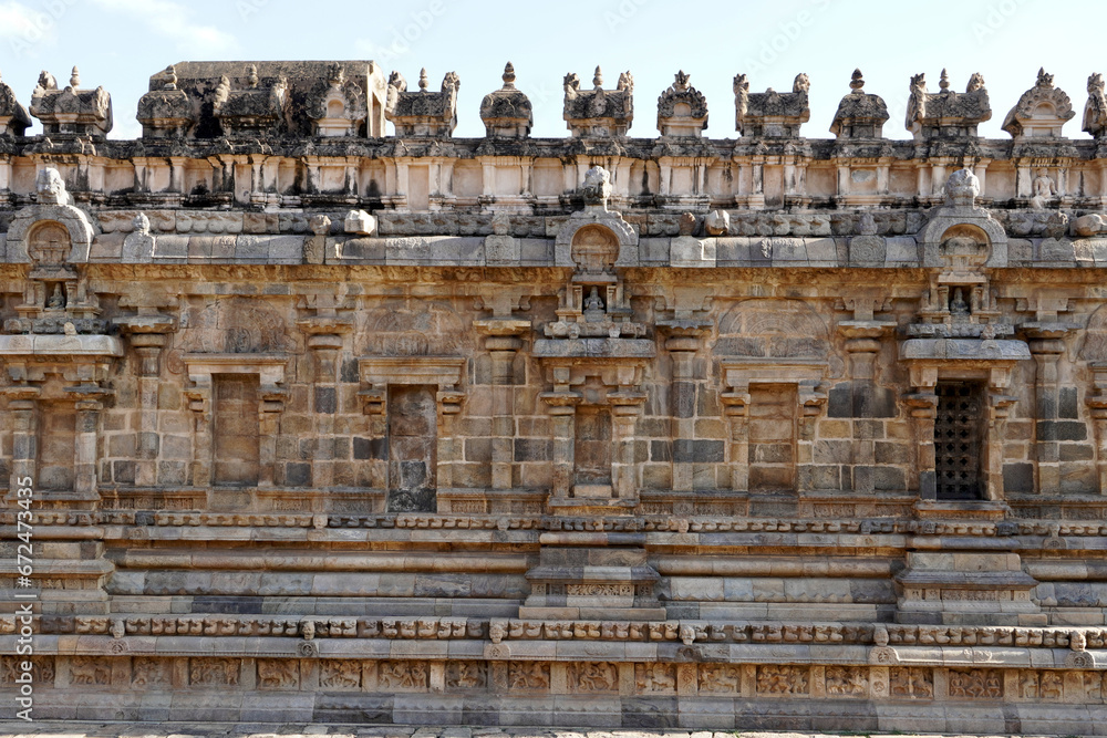 Temple wall with relief carvings. Stone wall of ancient Indian temple of Airavatesvara Temple, Darasuram, Kumbakonam, Tamilnadu.