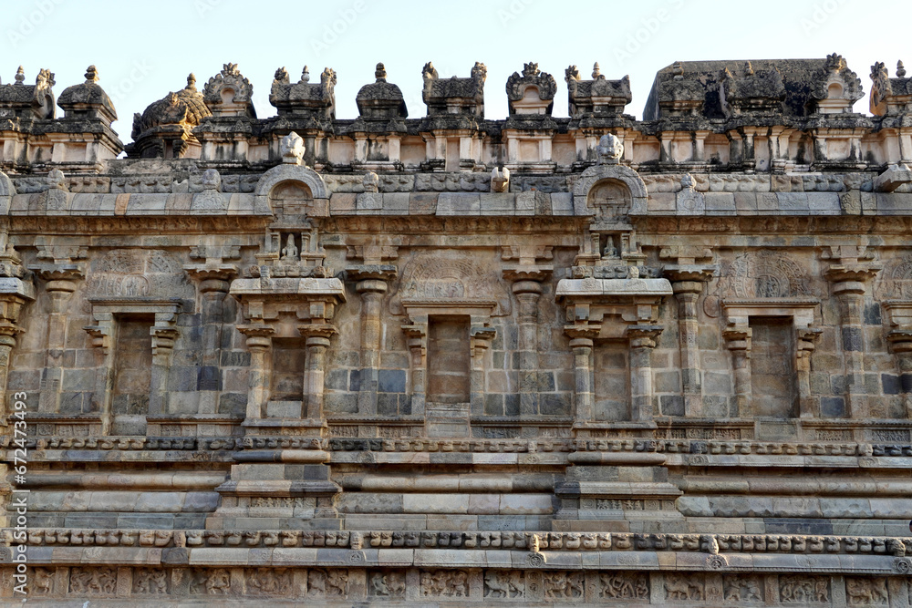 Temple wall with relief carvings. Stone wall of ancient Indian temple of Airavatesvara Temple, Darasuram, Kumbakonam, Tamilnadu.